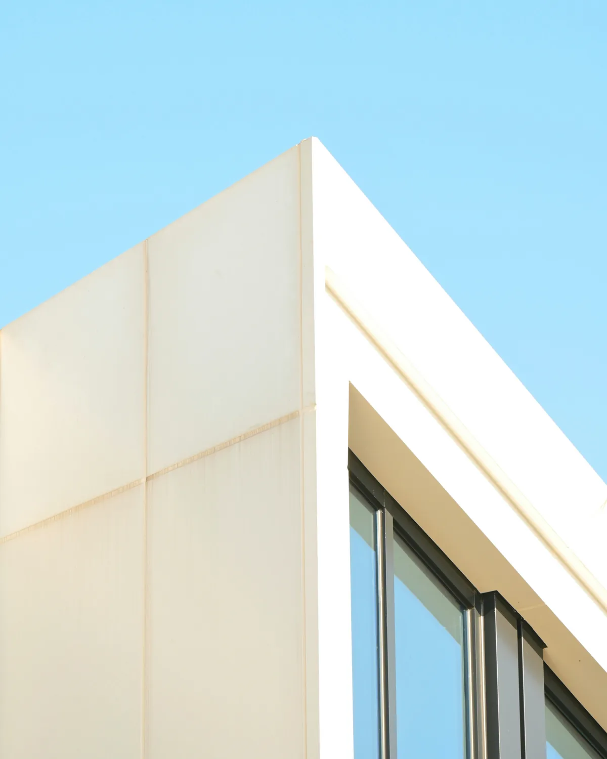 Corner of a light industrial building where panel meets glazing